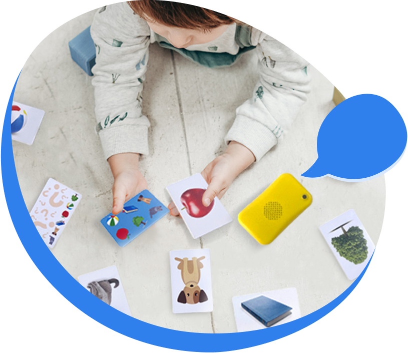 A child playing with My First Words cards and Talkido Mio
